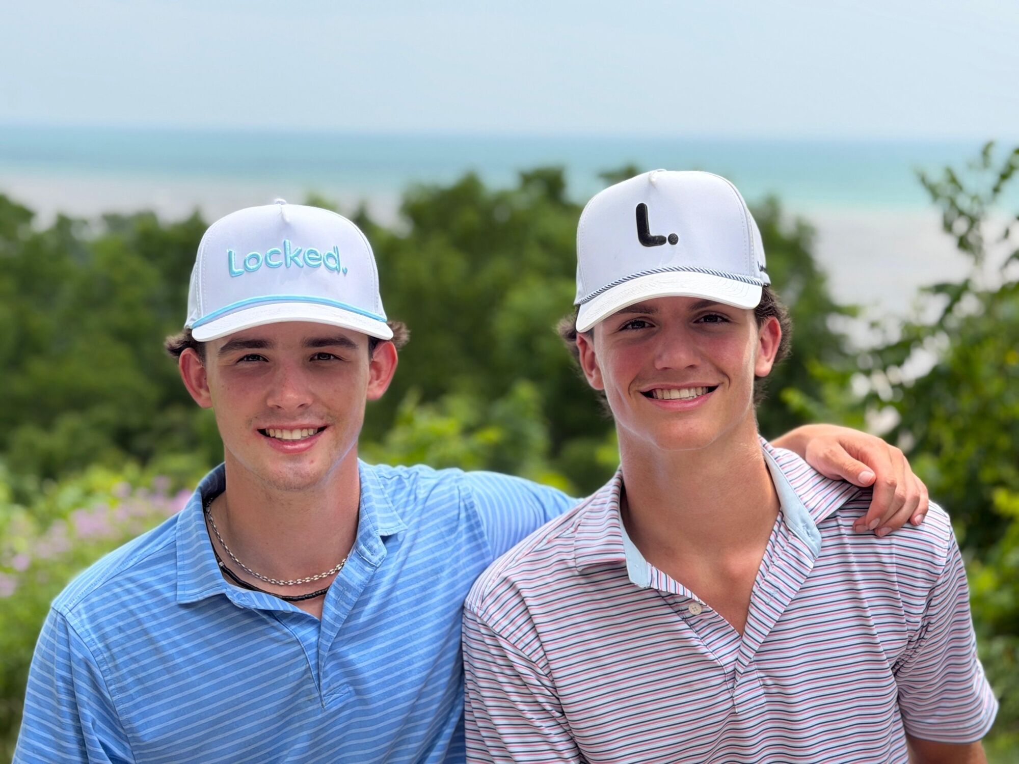 Duncan and Theo, the founders of Locked., wearing the Crisp and L. hats